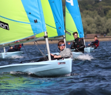 A group of people sailing really fast on the lake.