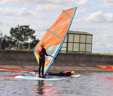 Someone standing up on a surfboard.