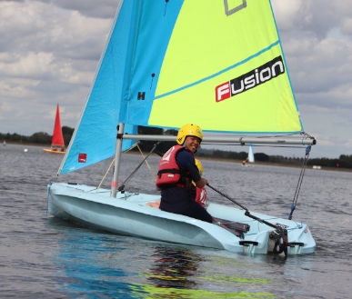 A youth in a Fusion sailing boat.