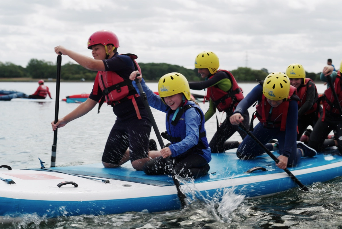 Youths paddling on the reservoir.