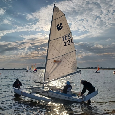 A challenger sailing boat in the sunset.