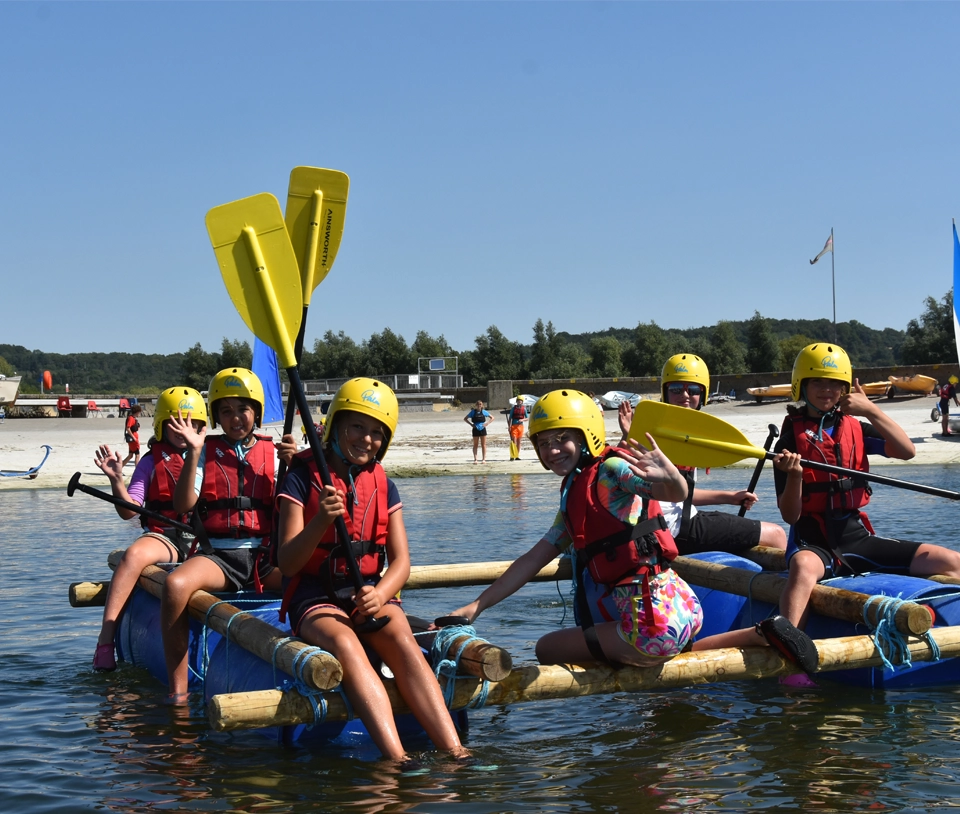 Youths paddling on the water.