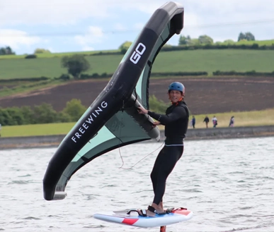 A junior with a wing on the lake.