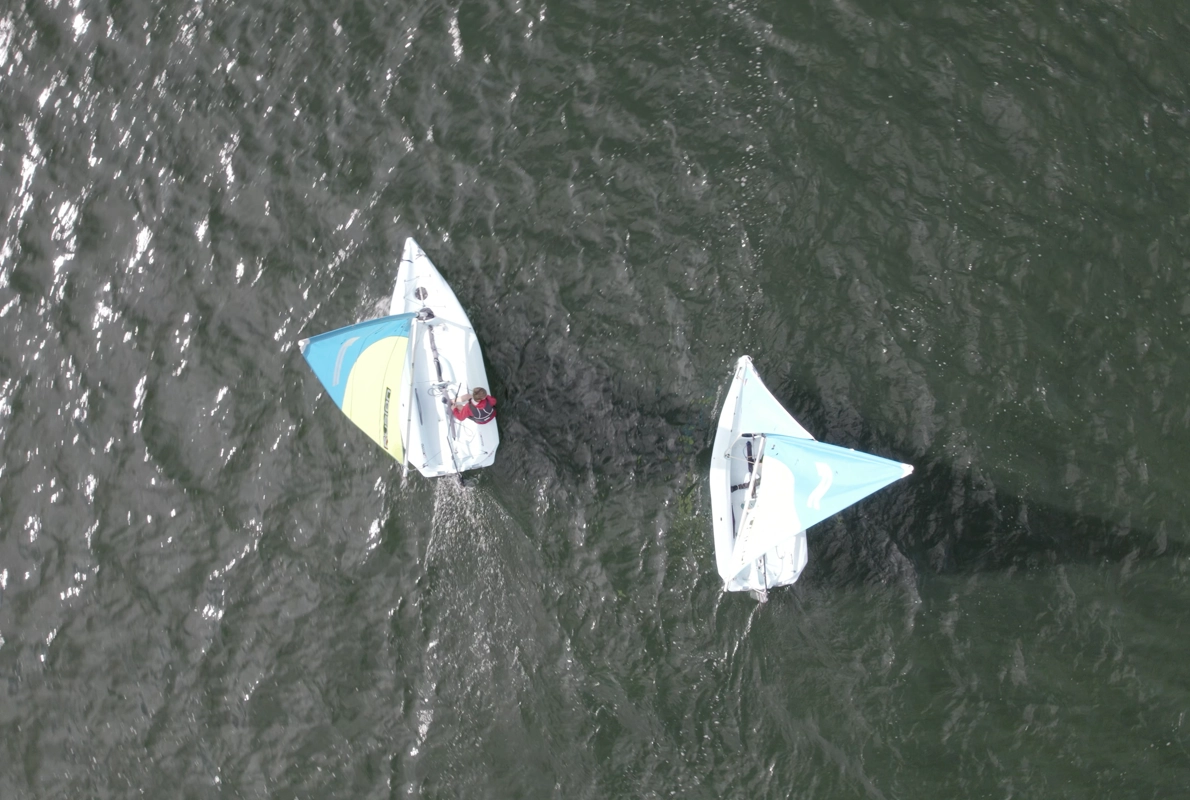 Two sailing boats on a lake.
