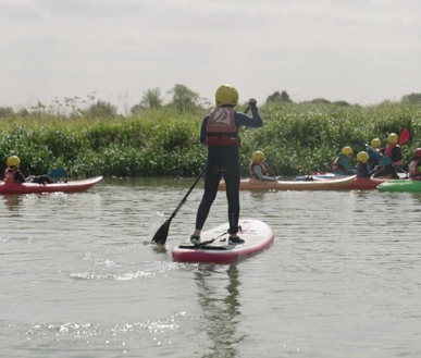 A youth paddling on the river.