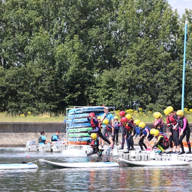 a party of youths jumping in the lake