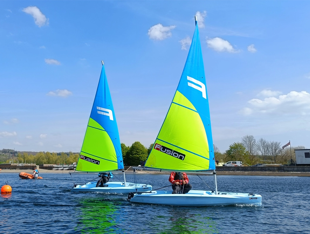 Two people in sailing boats.