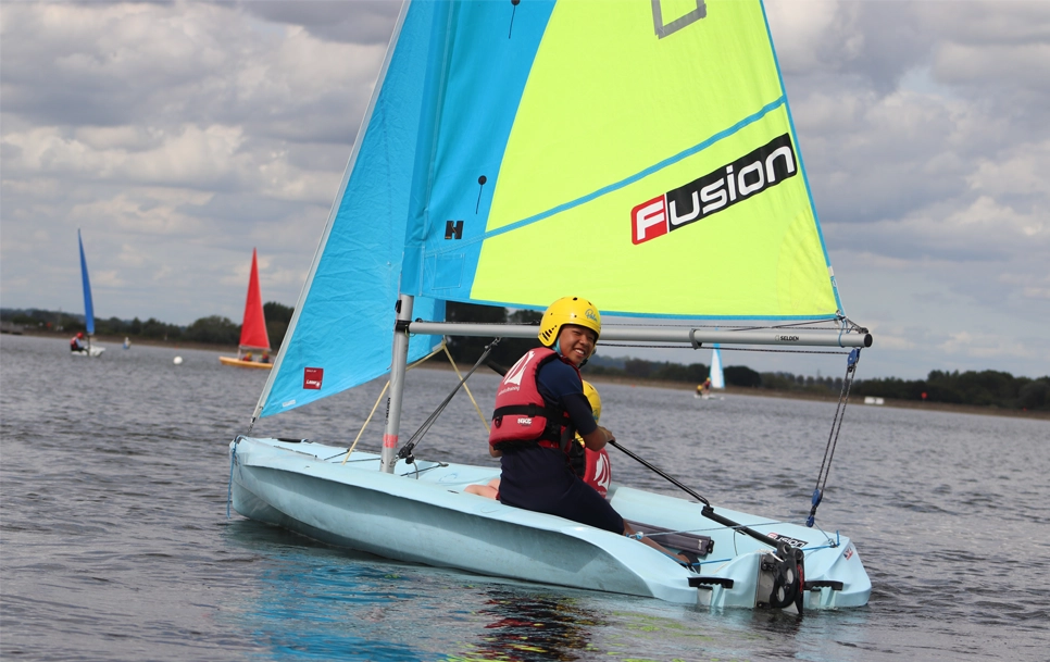 A youth sailing on the lake.