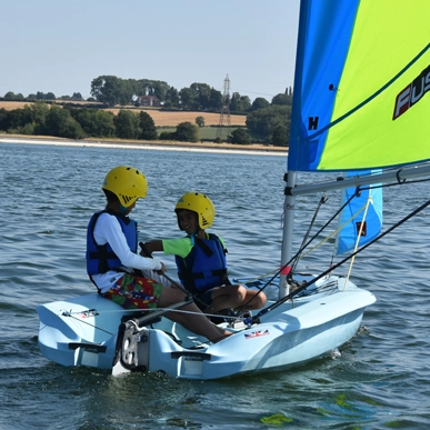 Two youths sailing together.