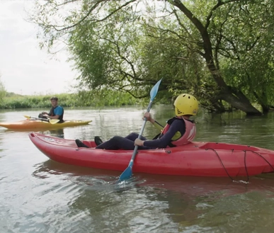 A youth paddling on the river.