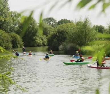 Youths paddling on the river.